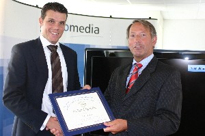 Ron Borstel (l), account manager, defense and homeland security, CycloMedia Technology, receives a token of thanks from Cdre. Schoonderbeek for his presentation, 